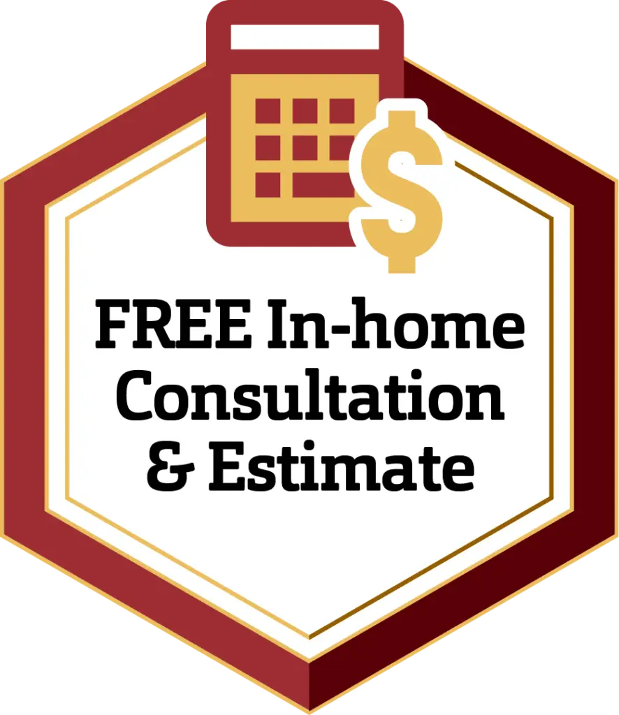 A hexagonal badge with a maroon border containing a calculator and a dollar sign icon at the top. The text inside reads, "FREE In-home Consultation & Estimate" in bold black letters on a white background.