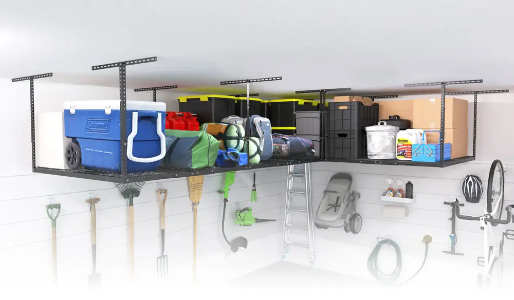 A neatly organized garage features overhead shelving loaded with various items, including a blue cooler, camping gear, storage bins, and fuel containers. Below, tools like shovels, rakes, and a hose are hung on the wall. A ladder and a bike are also visible.