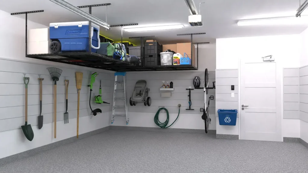 A clean, organized garage with gardening tools hanging on the wall, a hose reel, ladder, bike, and recycling bin. Overhead shelves hold bins and storage containers—a perfect example of smart garage storage and a true storage upgrade.
