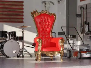 A luxurious red and gold throne with a crown rests in a modern garage, surrounded by musical instruments, a drum set, an American flag wall art, and lawn equipment—an unforgettable Father’s Day gift scene.