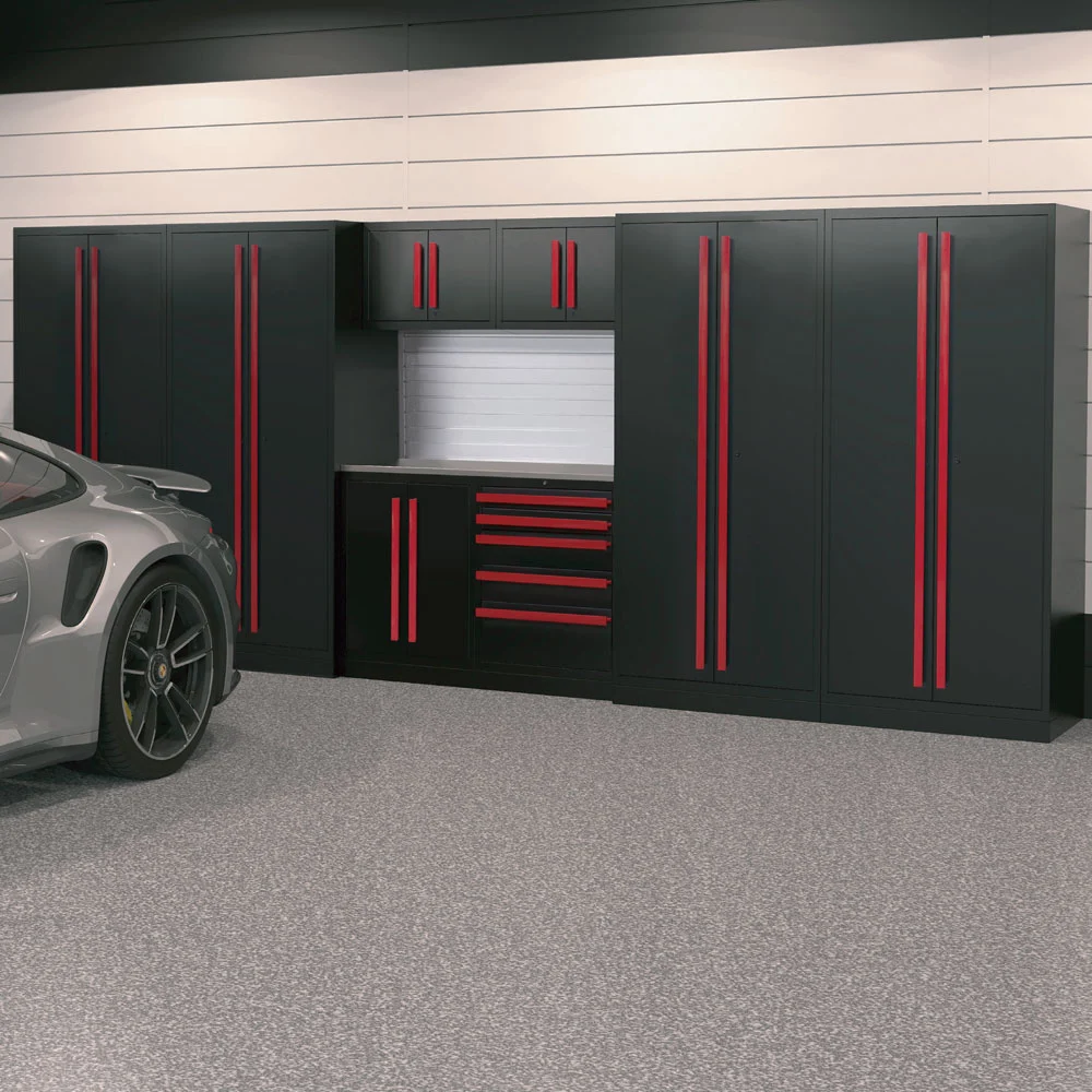 A sleek garage with a gray floor, featuring black Garage Cabinets with vertical red handles, and a gray sports car parked partially in view on the left side.