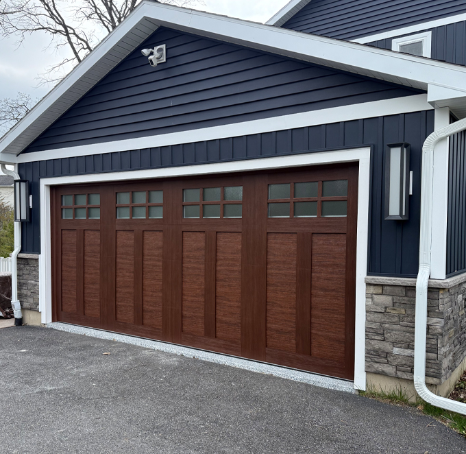 Garage Kings replaced an aging, low-quality garage door with a beautiful brown-toned garage door.
